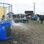 OS Fire Capt. Mike Thuirer was dunked multiple times by 9-year-old Shayna, a lacrosse player, during the Paddle the Shores event Saturday at Oyhut Bay.
