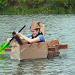 photos by Kat Bryant | Grays Harbor News Group                                Kennedy Birley of Lacey frantically paddles her teams cardboard creation, the Yar, back to shore during Saturdays event at Oyhut Bay.