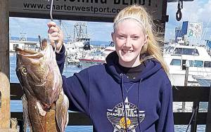 COURTESY WESTPORT WEIGHMASTER                                Right: Bottomfishing trip out of Westport are still producing lots of rockfish and some pretty big lingcod. Ryliegh Earl from Loon Lake, 14, brought this 23.8-pound lingcod to the derby scales Sept. 2.
