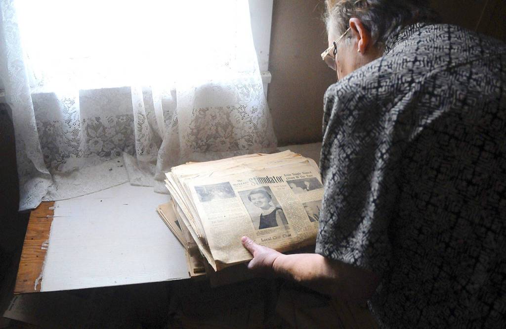 McCleary Historical Society President Linda Thompson goes through a pile of old copies of the McCleary Stimulator in the attic of the McCleary Museum.