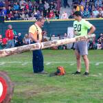 Emcee Don Bell chats with competitor Chester Isaacson after his chainsaw ripped off part of his loose gym shorts.
