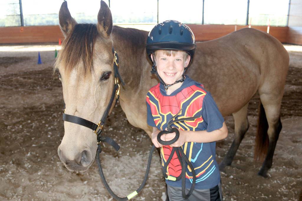 Photo courtesy Kimberly Iverson                                Cadon Vogel, 9, shares a moment with Ginger during the Horse Prayer event.
