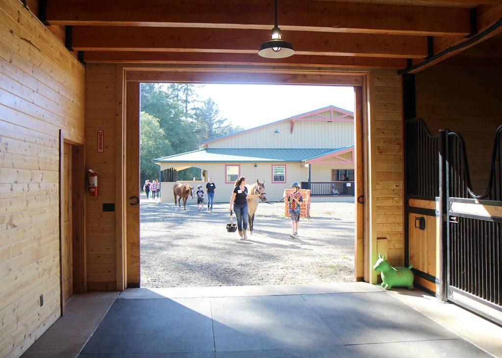 Michael Lang | Grays Harbor News Group                                Visitors and volunteers lead horses back to the stables at the end of the event.