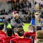 Hoquiam head coach Jeremy McMillan talks to his team while standing next to the Myrtle Street Rivalry Trophy after Hoquiams 56-3 win over Aberdeen on Friday night at Olympic Stadium. (Hasani Grayson | Grays Harbor News Group)
