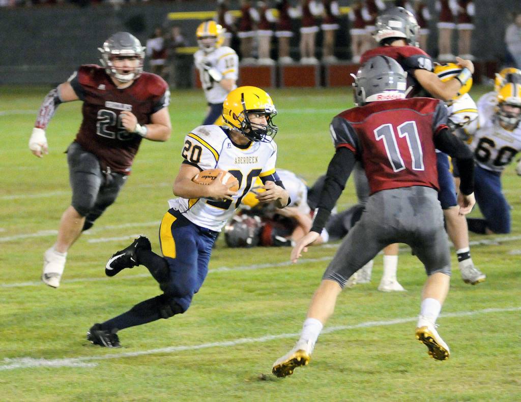 Aberdeens Ethan Morrill (20) runs for a first down in the second quarter against Hoquiam at Olympic Stadium on Friday. (Hasani Grayson | Grays Harbor News Group)
