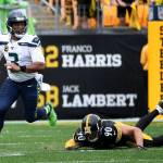 Seattle Seahawks quarterback Russell Wilson (3) scrambles out of the pocket against T.J. Watt (90) of the Pittsburgh Steelers in the second half on Sunday at Heinz Field in Pittsburgh, Pa. (Justin Berl | Getty Images/TNS)