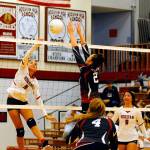 Hoquiams Chloe Kennedy, goes for a kill in the third set while Ocostas Kiana Morrow jumps at the net to block on Wednesday a tHoquiam High School. (Hasani Grayson | Grays Harbor News Group)