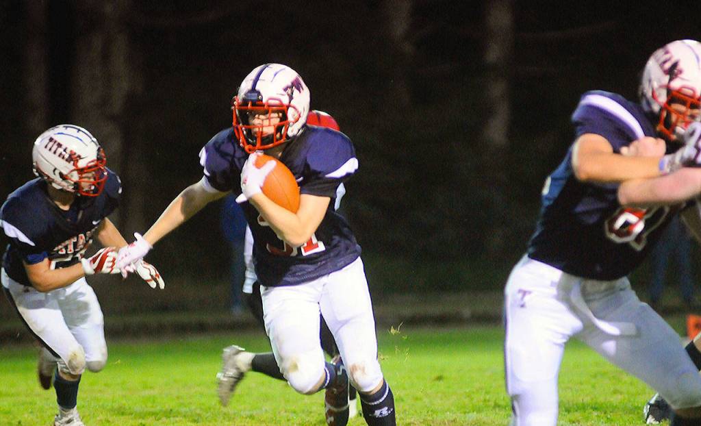 Pe Ell-Willapa Valley running back Bubba Isaken runs through a whole on the left side of the line in the second quarter of a game against Raymond on Friday. (Hasani Grayson | Grays Harbor News Group)