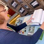 Photos by Kat Bryant | Grays Harbor News Group                                Becky Carossino shows a binder compiled by the Aberdeen VFW on local soldiers who were killed in action.