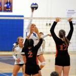 Elma middle blocker Sarah Bridge (10) hammers home a kill during the Eagles four-set victory in Elma on Monday. (Ryan Sparks | Grays Harbor News Group)