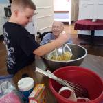 Photo courtesy Pacific Care                                Pacific Care resident Johnny Schroeder re-created some fond memories recently while making banana bread. Zach West, the 8-year-old son of Pacific Care activity assistant Ashley Nelson, happened to be on-site that day. Johnny was mashing bananas and remembering making bread with his children, and Zach was here helping out, said activity director Shannon Ashlock. The smile on his face was priceless!