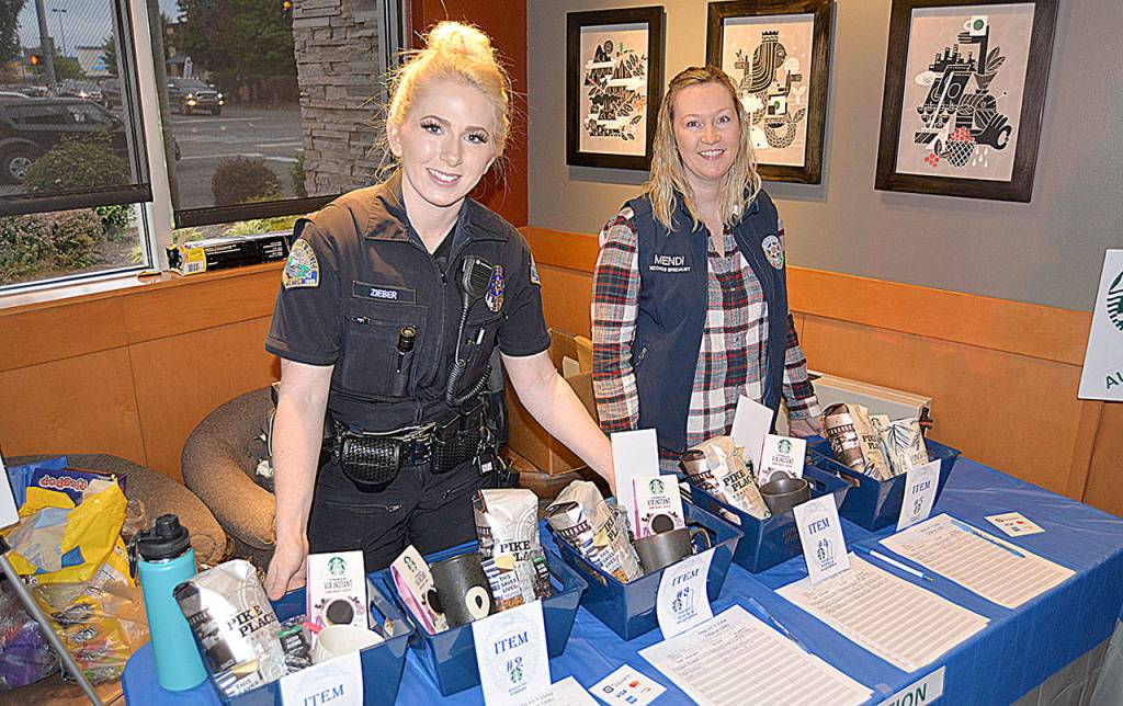 Starbucks donated several baskets for a silent auction to benefit the Aberdeen Police Officers Guild. Manning the table were Officer Brandi Zieber and records specialist Mandi Stump.