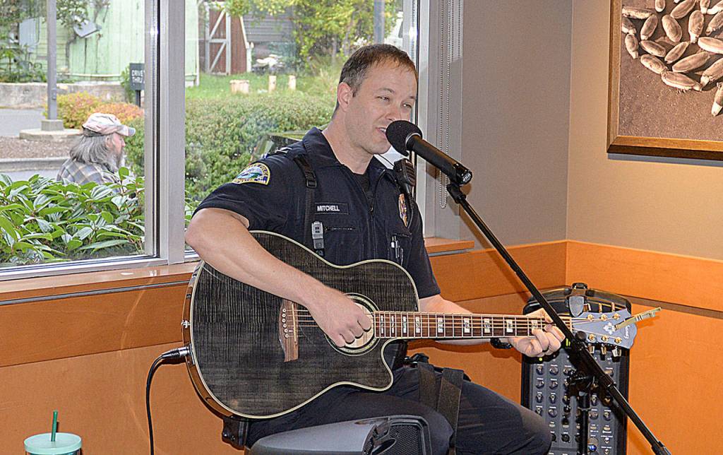 Aberdeen Police Officer Jackie Mitchell played two sets during the music by a cop portion of the Oct. 2 event at the Wishkah Street Starbucks.