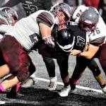 Hoquiams Matt Brown, right, and Junior Ensminger team up for a tackle on Teninos Dylan Spicer in the second quarter on Friday. (Hasani Grayson | Grays Harbor News Group)