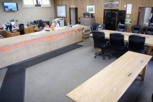 The Cosmopolis City Hall is a converted bank building, complete with safe and drive-thru window. On Tuesday, Oct. 8, a worker sits behind the counter across from the table where City Council meetings are held. Officials say they are running out of space and need a new building to ensure worker safety and proper security of evidence and documents. (Michael Lang | Grays Harbor News Group)