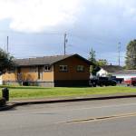 A new Cosmopolis Police Station would be in the field at left, seen here Tuesday, Oct. 8, 2019. At right is the former bank building that houses the City Hall. In the center is the mobile building that houses the citys Police Station, which was built in 1971. (Michael Lang | Grays Harbor News Group)