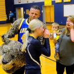 Hasani Grayson | Grays Harbor News Group                                Aberdeen volleyball player Abby Baumgardner, left, and her sister Kayla Heden share tears after Army Sgt. Bradley Heden surprised Baumgardner by revealing himself before a match on Wednesday.