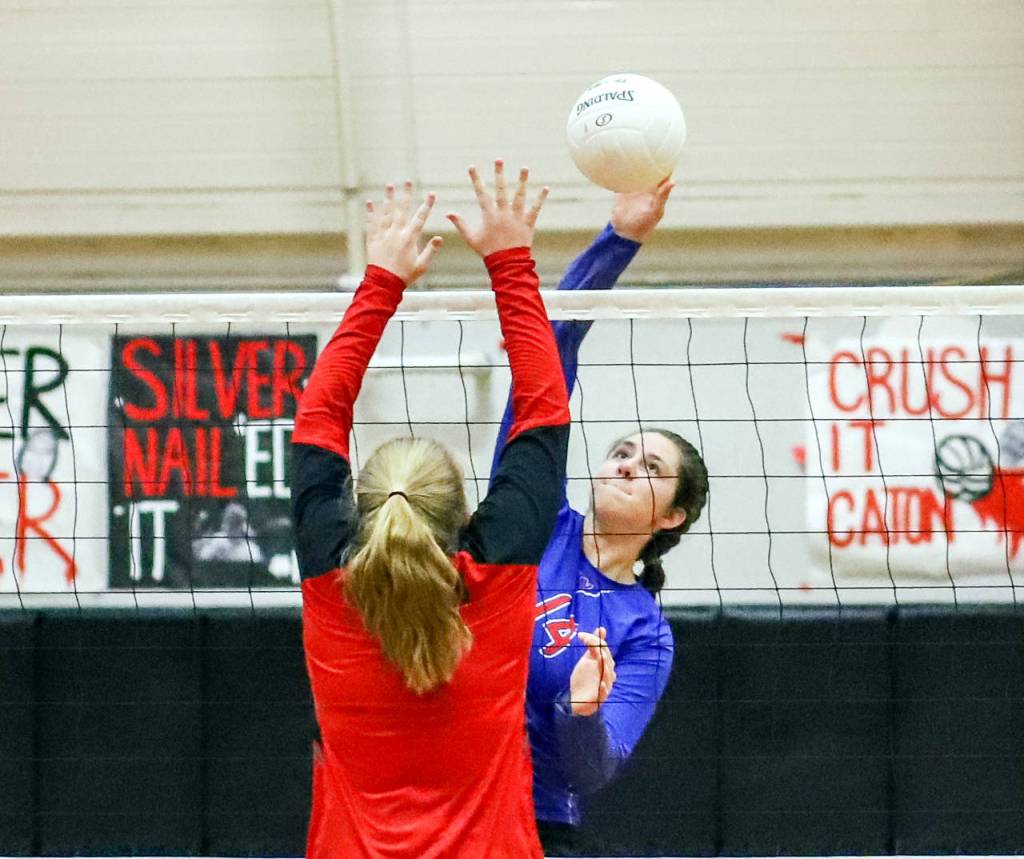Willapa Valleys Hallee Layman, background, smashes a kill attempt while Raymonds Grace Busenius defends during the Vikings 3-1 victory over the Seagulls on Thursday at Raymond High School. (Photo by Larry Bale)