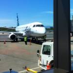 An Alaska Airlines plane pulls up to the gate at Paine Field this summer. (Sue Misao / Herald file)