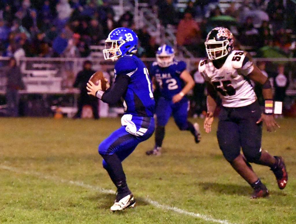 Elma quarterback Cody Vollan looks to pass downfield against Tenino on Friday in Elma. Vollan threw for 183 yards and four touchdowns in the Eagles 54-7 victory. (Photo by Sue Michalak Budsberg)
