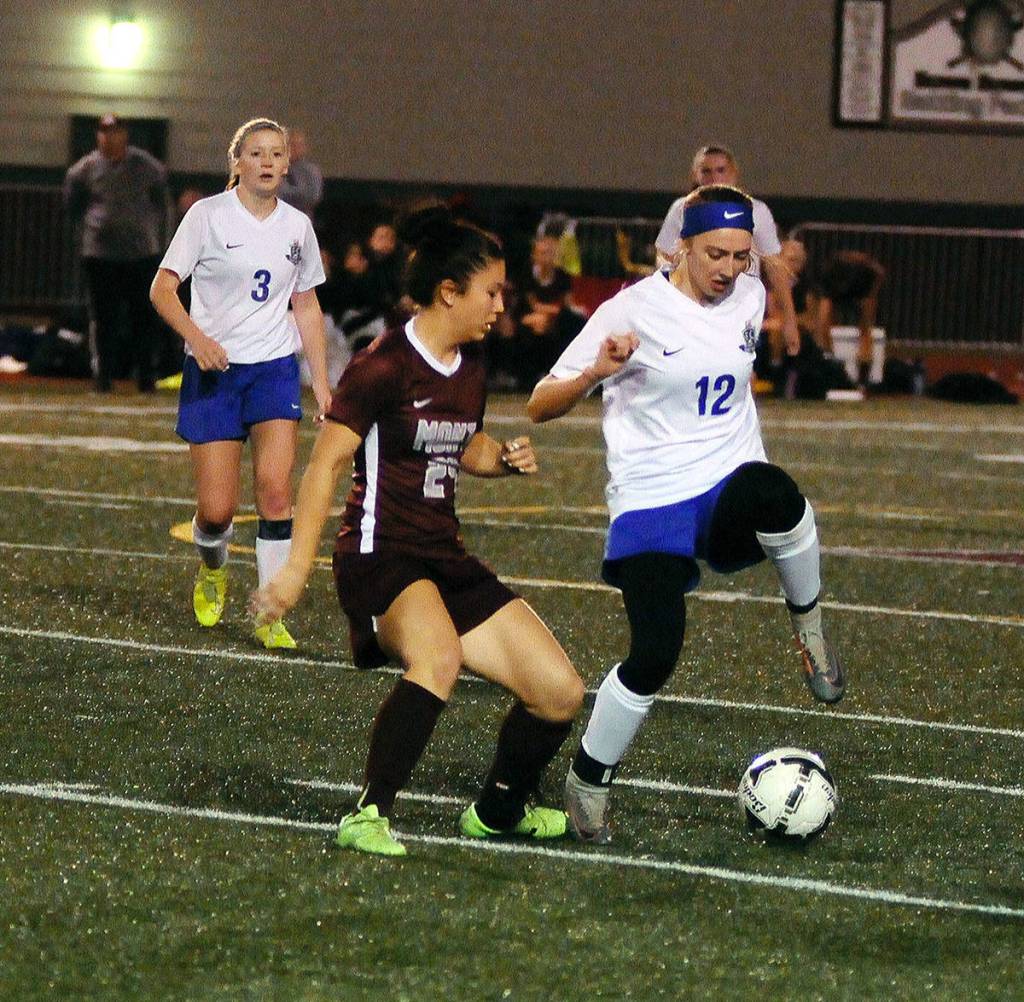 Elmas Jillian Bieker (12) protects the ball from Montesanos Vanna Prom late in the second half of a match on Thursday at Jack Rottle Field. (Hasani Grayson | Grays Harbor News Group)