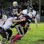 Pe Ell Willapa Valleys Kollin Jurek, middle, drags Ocosta Brandon Thomas in the first quarter on Friday at Willapa Valley High School. (Hasani Grayson | Grays Harbor News Group)
