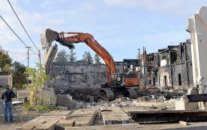 DAN HAMMOCK | GRAYS HARBOR NEWS GROUP                                Crews from Rognlins tear down the southeast walls of the Aberdeen Armory building on East Third Street in Aberdeen Monday morning. The building, which burned June 9, 2018, is the former home of the Aberdeen Museum of History, the Coastal Community Action Program and a senior center.