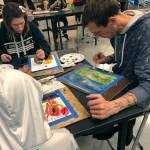 Courtesy photo                                James and Alyssa Lano, parents of art student Tegan Lano (foreground, in hoodie), experiment with watercolors.