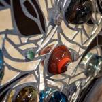 This dynamic 30- by 32.5-inch piece was created by local glass artists Michelle Lester and Jeremy Bartheld.