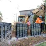 photos by Michael Lang | Grays Harbor News Group                                 City of Montesano and Aberdeen Cemetery Association personnel add a fourth marble monument to the Marion J. Bogey Bogdanovich Veterans Honor Wall on Thursday, Oct. 31, at Fleet Park in Montesano.