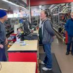 Kat Bryant | Grays Harbor News Group                                Manager Kellie Nordberg, center, talks with longtime customer Greg Walczyk on Friday as employee Carol Powers looks on.