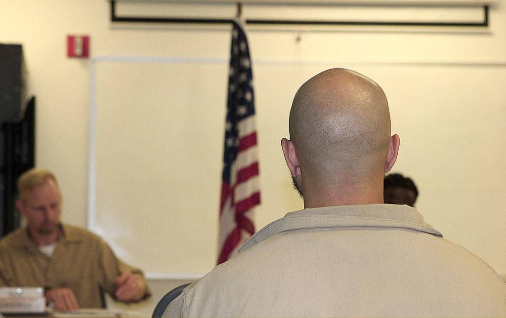 COURTESY PHOTO                                Inmates look at the flag during an American Legion meeting at Stafford Creek Corrections Center Oct. 16.