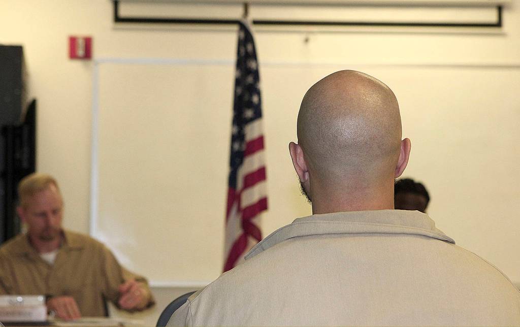 COURTESY PHOTO                                Inmates look at the flag during an American Legion meeting at Stafford Creek Corrections Center Oct. 16.