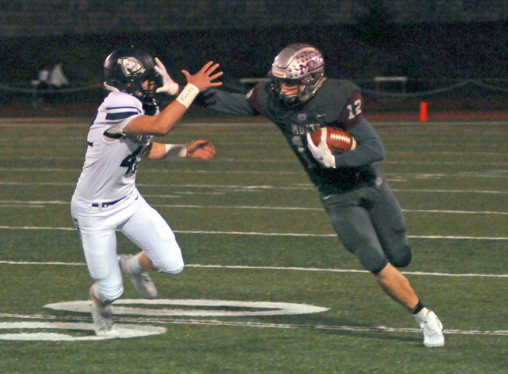 Montesano receiver Sam Winter stiff-arms Kings Way Christian defender Kai Butterworth en route to a 57 yard touchdown reception during Fridays game in Montesano. (Ryan Sparks | Grays Harbor News Group)