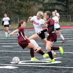 Montesanos Jaiden King, left, and Cassadie Golding, right, defend against Teninos Morgan Miner during Saturdays district title game at Tenino High School. (Photo by Shawn Donnelly)