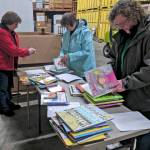 Courtesy photo                                From left, Annette Biornstad, Jennifer Roetcisoen and Joan Julius review and label books for Altrusa International of Central Grays Harbors Little Red Book Shelf Project. The service organization places childrens books all over the Harbor for families to take home and read. (Current locations include Grays Harbor Community Hospital, the Domestic Violence Center of Grays Harbor, and the Grays Harbor County Public Health & Social Services Department offices.) The Altrusa International Foundation recently awarded a $2,000 grant to the local group to purchase shelves and over 1,700 new and used books.