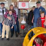 Kat Bryant | Grays Harbor News Group                                Four generations of bell-ringers, from left: John Beck, Carter Fuchs, Kim and Steve Fuchs, Kathy and Steve Beck, and Evan Fuchs. Nattie Mae Olive is in the toy car.