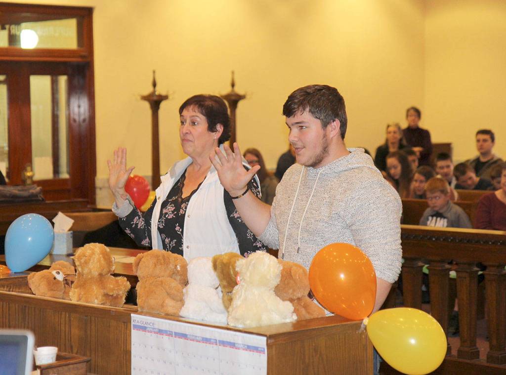 Anne Ramsey and Erick Hayter-Ramsey are sworn in Friday during the National Adoption Day ceremony in Judge Stephen Browns courtroom at Grays Harbor County Superior Court in Montesano. (Michael Lang | Grays Harbor News Group)