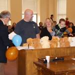 Newly adopted, Kasyn White reaches for a teddy bear Friday during the National Adoption Day ceremony in Judge Stephen Browns courtroom at Grays Harbor County Superior Court in Montesano. (Michael Lang | Grays Harbor News Group