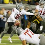 Washington State quarterback Anthony Gordon (18) scrambles as he tries to avoid a sack by Oregon linebacker Mase Funa during the second quarter at Autzen Stadium. (Andy Nelson/The Register-Guard)