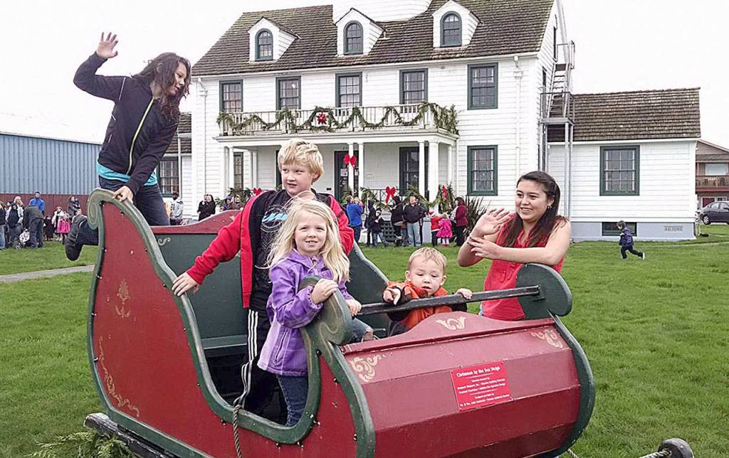 COURTESY PHOTO                                Kids crawl on Santas sleigh outside the Westport Maritime Museum. Santa arrives at the museum at 10:30 a.m. Saturday to meet with the kids as part of the annual Santa by the Sea celebration.