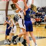 Raymonds Kyra Gardner, left, goes up for a shot while being defended by Elmas Jalyn Sackrider during Raymonds 49-47 victory on Tuesday at Raymond High School. Gardner led all scorers with 30 points. (Photo by Larry Bale)