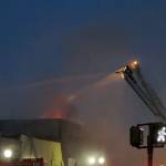 COURTESY DANIEL HOEFS                                Flames are visible from the roof of a building at 115 W. Heron St. early Saturday morning. The early morning fire gutted the building, which formerly housed C&C Motor Sports on the ground floor and the Revival Grays Harbor on the second.
