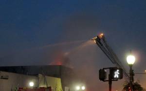 COURTESY DANIEL HOEFS                                Flames are visible from the roof of a building at 115 W. Heron St. early Saturday morning. The early morning fire gutted the building, which formerly housed C&C Motor Sports on the ground floor and the Revival Grays Harbor on the second.