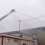 DAN HAMMOCK | GRAYS HARBOR NEWS GROUP                                An Aberdeen firefighter puts out hot spots on the fire at 115 W. Heron St. in downtown Aberdeen Saturday morning.