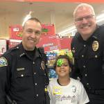 COURTESY HOQUIAM POLICE DEPARTMENT                                Aberdeen Police Chief Steve Shumate, left, and Hoquiam Police Chief Jeff Myers with a 2019 Shop with a Cop participant at the Walmart Saturday morning.