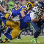 eattle Seahawks quarterback Russell Wilson (3) is sacked by Los Angeles Rams outside linebacker Samson Ebukam (50) and defensive end Morgan Fox (97) during first quarter action at LA Memorial Coliseum on Sunday. (Robert Gauthier | Los Angeles Times)