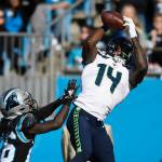 Seattle Seahawks wide receiver D.K. Metcalf (14) reaches up for a touchdown reception past Carolina Panthers cornerback Donte Jackson (26) during the first half at Bank of America Stadium on Sunday. (David T. Foster III/Charlotte Observer/TNS)