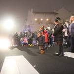 A girl takes a bite from a piece of candy tossed from one of the parade floats.