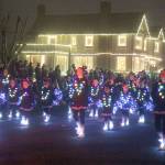Taillights from the vehicle in front of them help light up the Elma Youth Cheer squad during the parade.
